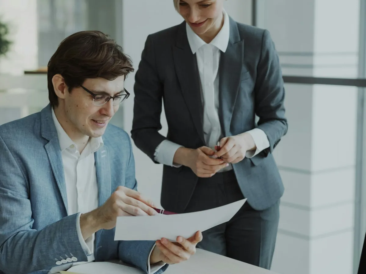 Two professionals reviewing a document together